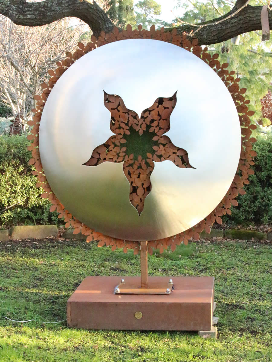 1.7m diameter, stainless steel, corten steel, LED and a tuft of faux turf, also available as wall hung