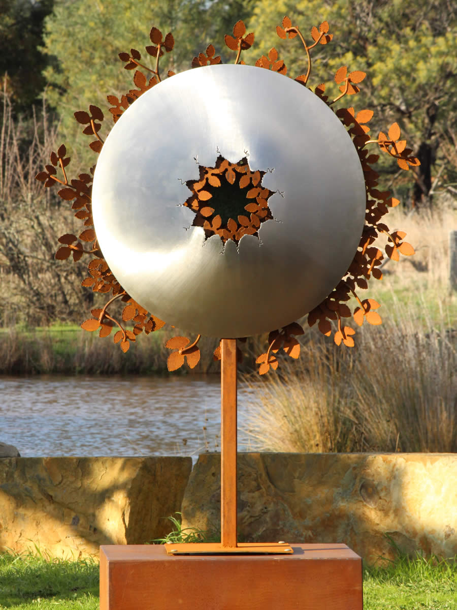 1.3m diameter, 2m tall, stainless steel, corten steel, LED and a tuft of faux turf, also available wall hung